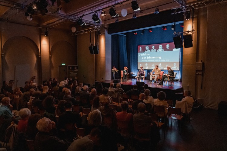 Photo of the vernissage with a view of the stage from the auditorium.