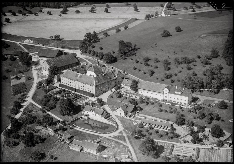 The aerial view shows the extensive grounds of the former monastery with residential and farm buildings as well as gardens and agricultural land.
